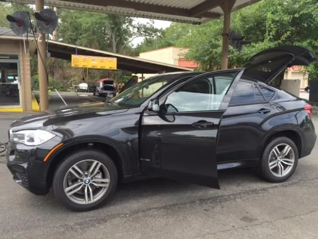 BMW X6 with doors open after a hand wash